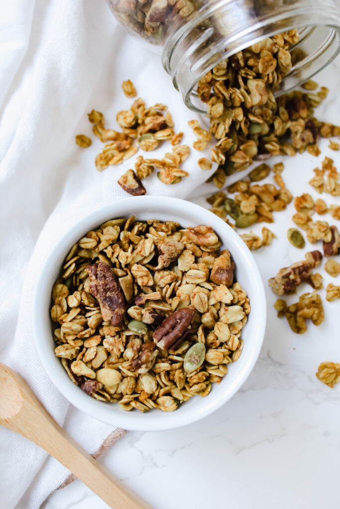 shot of pumpkin granola in a ramekin and spill out of the jar