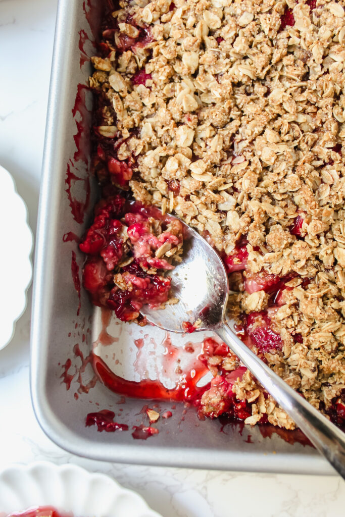 shot of the corner of the baking dish with a scoop taken out with a spoon