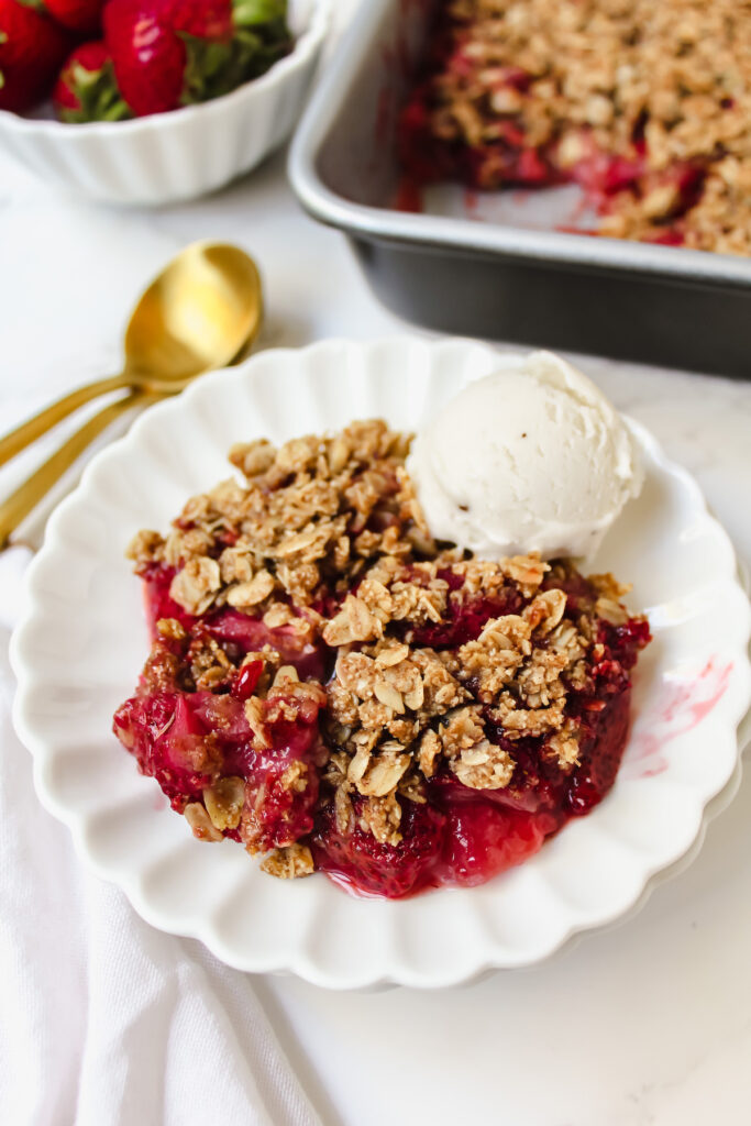 close up of strawberry crisp with ice cream