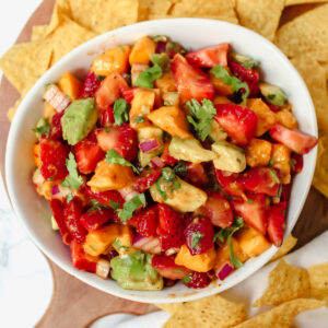 overview shot of strawberry mango avocado salsa with chips on the side