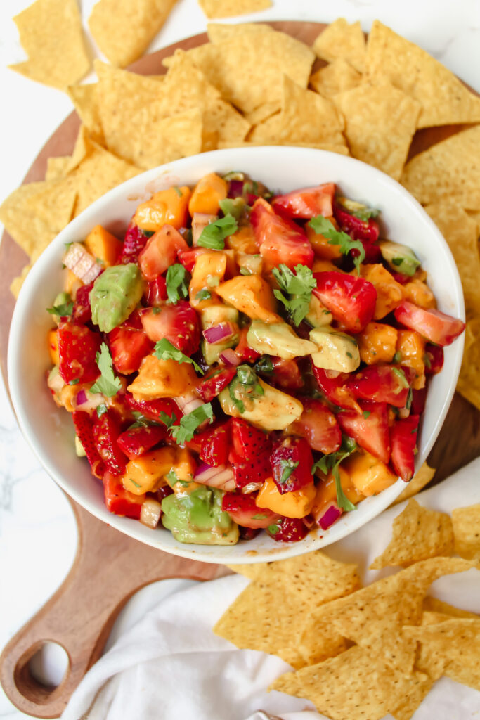 overview shot of strawberry mango avocado salsa with chips on the side