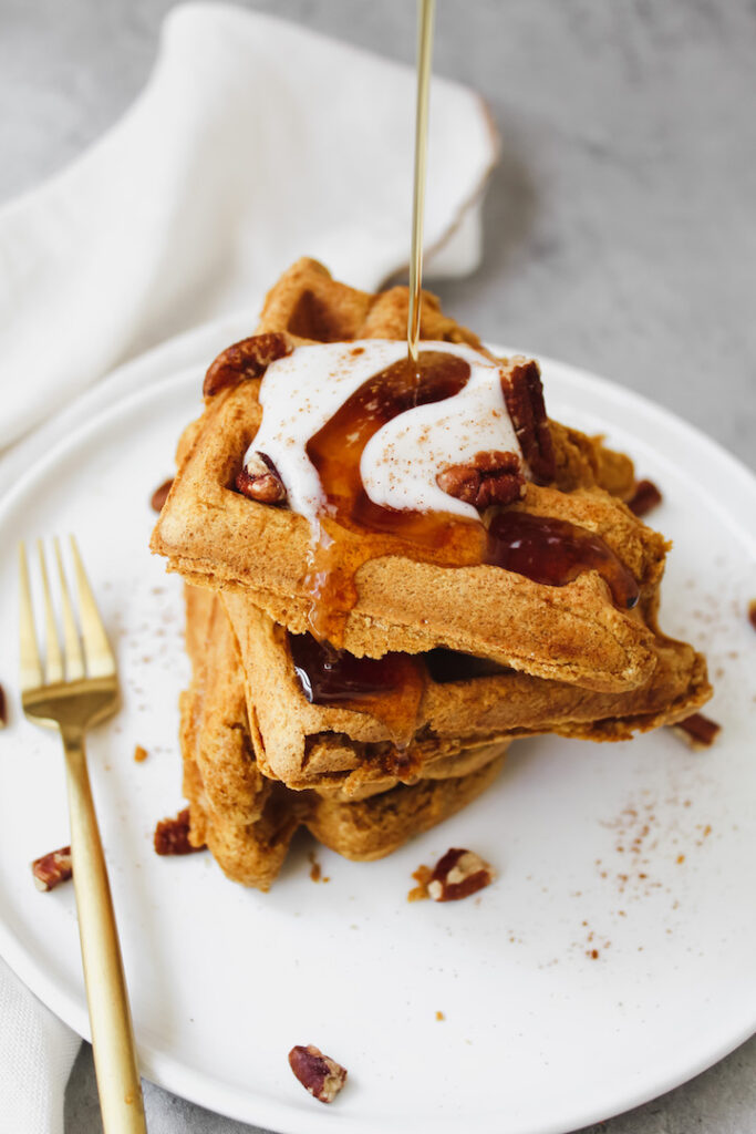 maple syrup drizzled on waffle stack