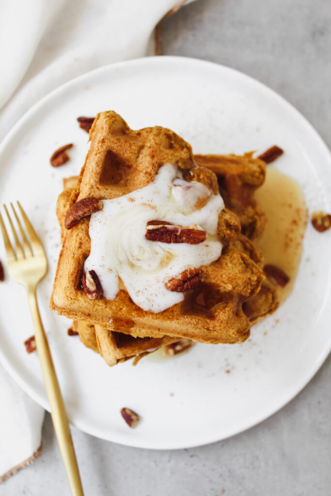 overview shot of pumpkin waffles with maple syrup