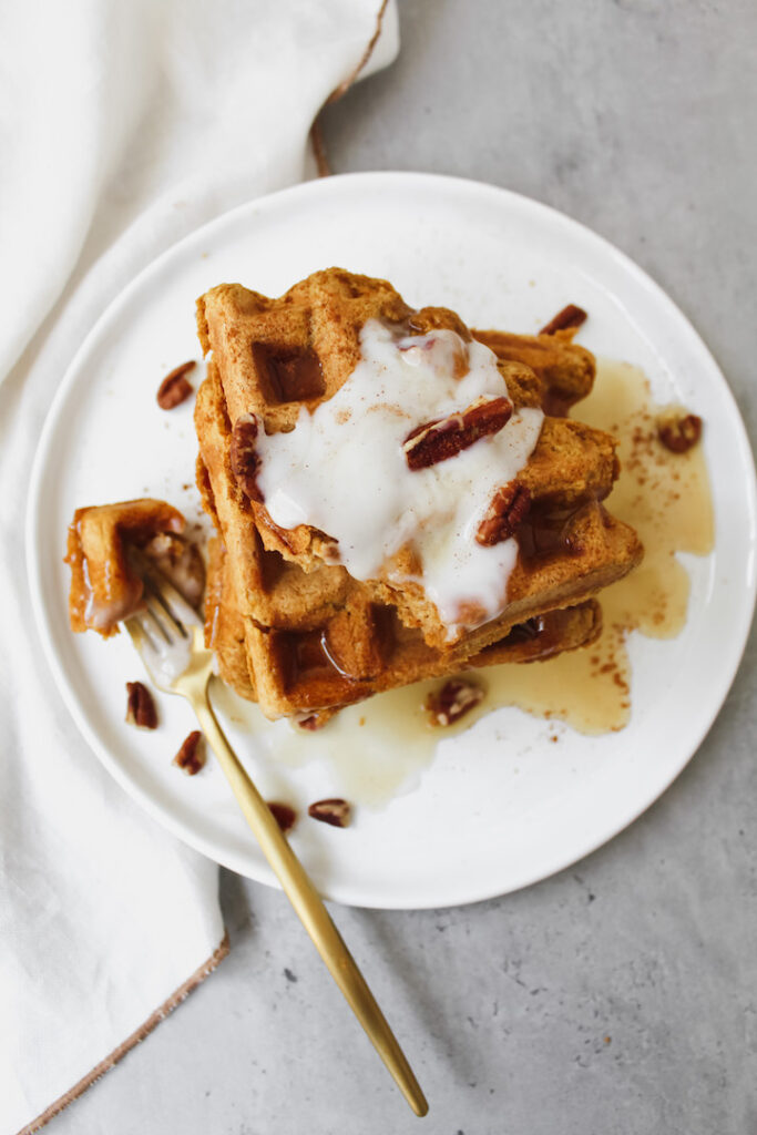 a bite taken out of the pumpkin waffles