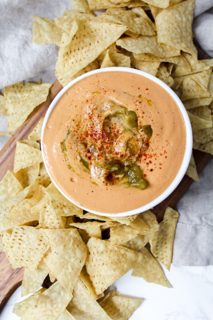 overview shot of the best queso with chips on the side