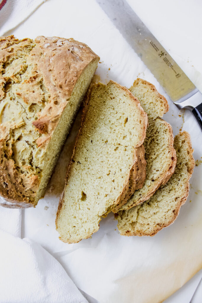 close up of loaf of bread and 3 slices of bread