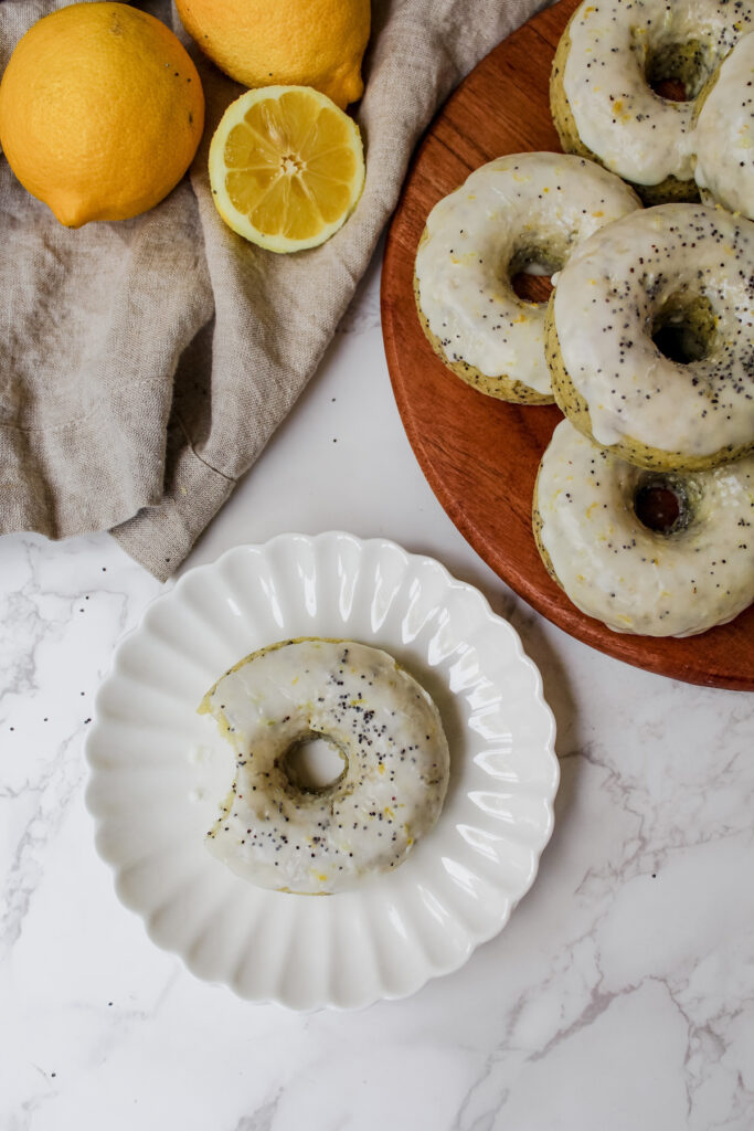 overview shot of a donut on a plate and donuts on a wooden board