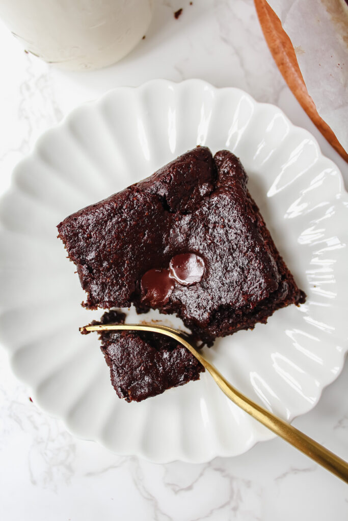 overview shot of a fork cut into the corner of a slice of brownie