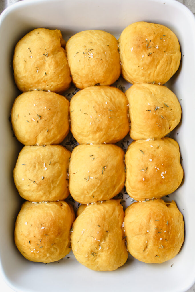 overview shot of entire batch of sweet potato rolls in the pan