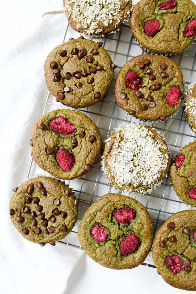 overview shot of healthy spinach banana muffins on a cooling rack