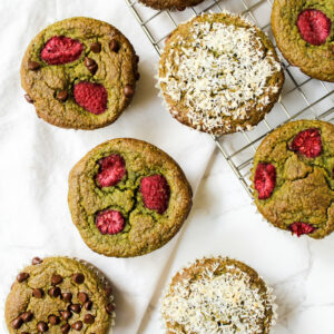 overview shot of muffins on a cooling rack and on the counter