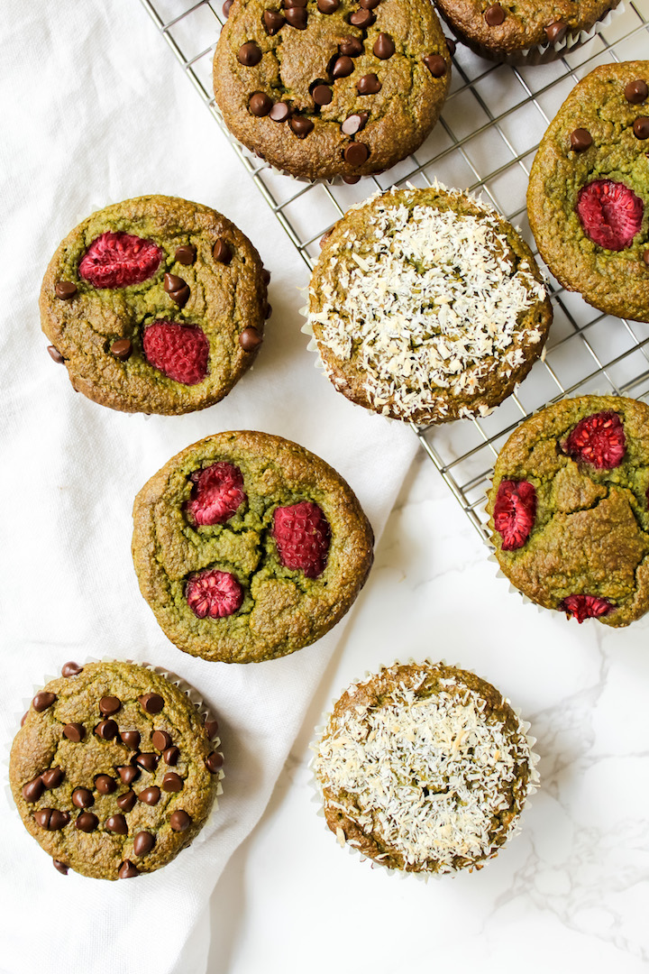 overview shot of muffins on a cooling rack and on the counter