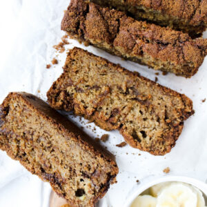 picture of banana bread with slices cut and part of the whole loaf