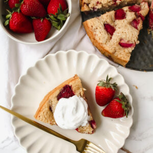 overview shot of a slice of cake with strawberries and coconut yogurt