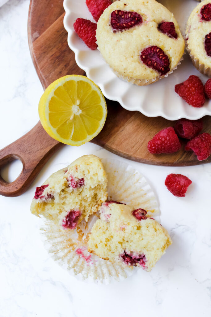 shot of a muffin split in half and muffins on plate