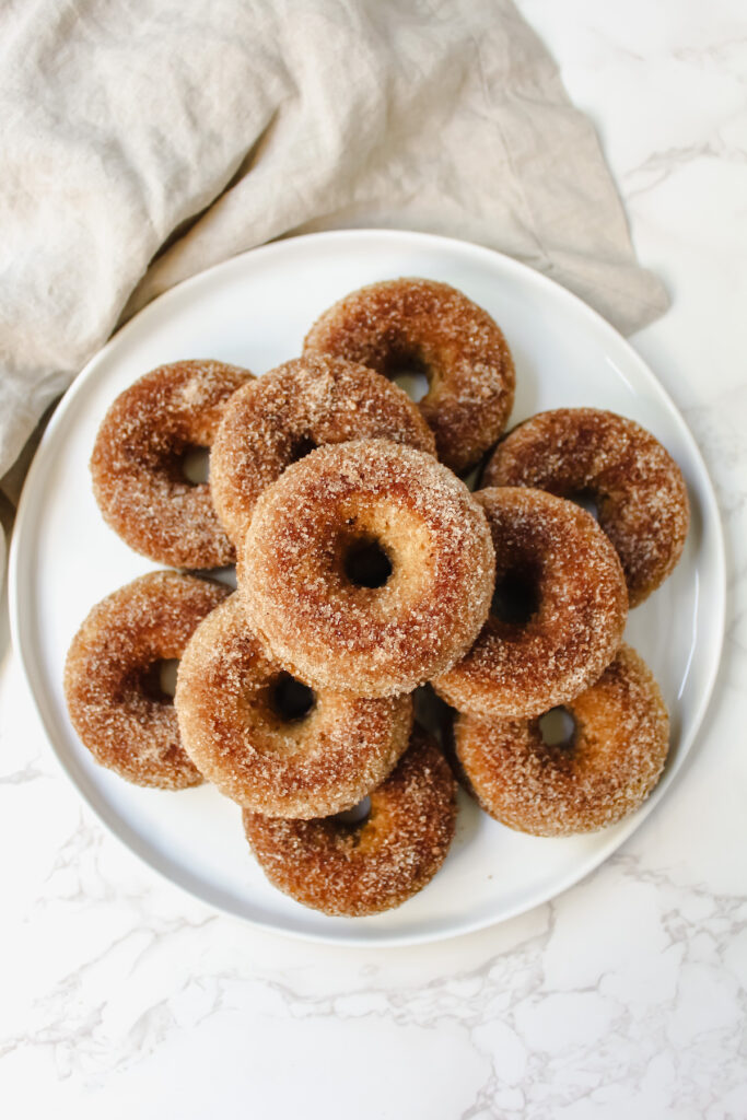 overview shot of entire plate of donuts stacked in a pyramid 