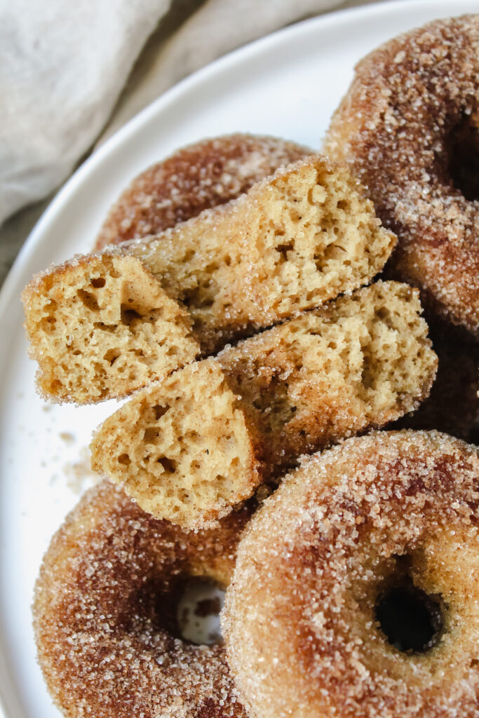 close up shot of an apple cider donut broken in half