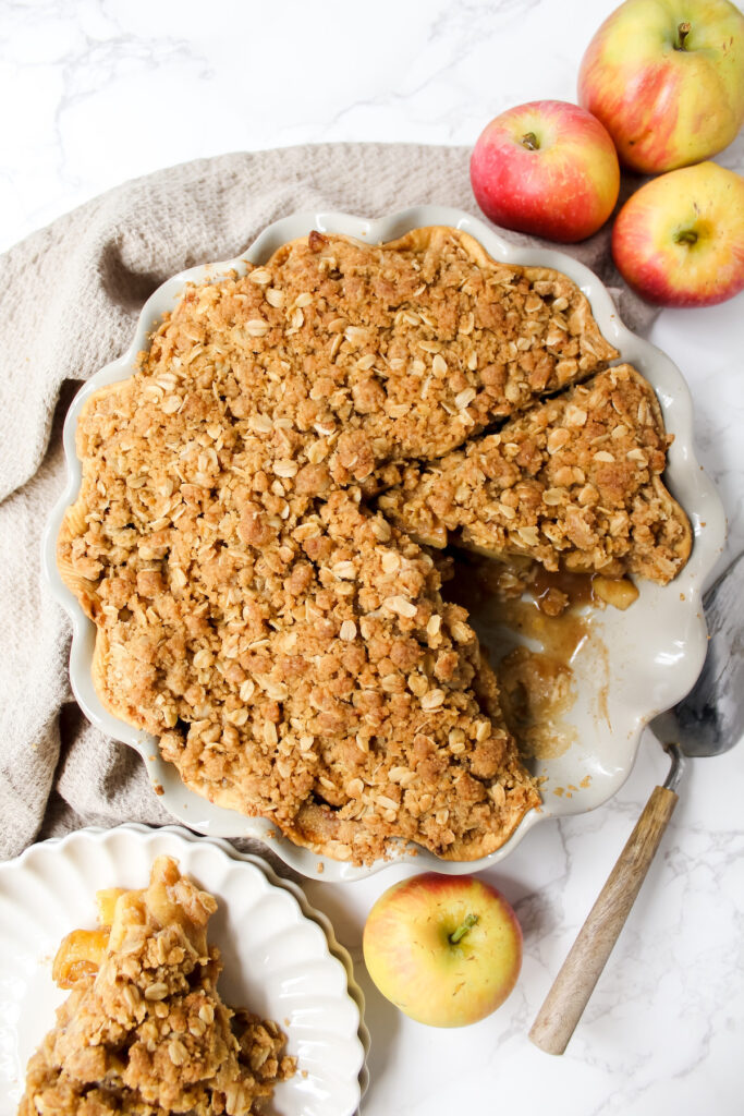 overview shot of apple pie with a slice cut out