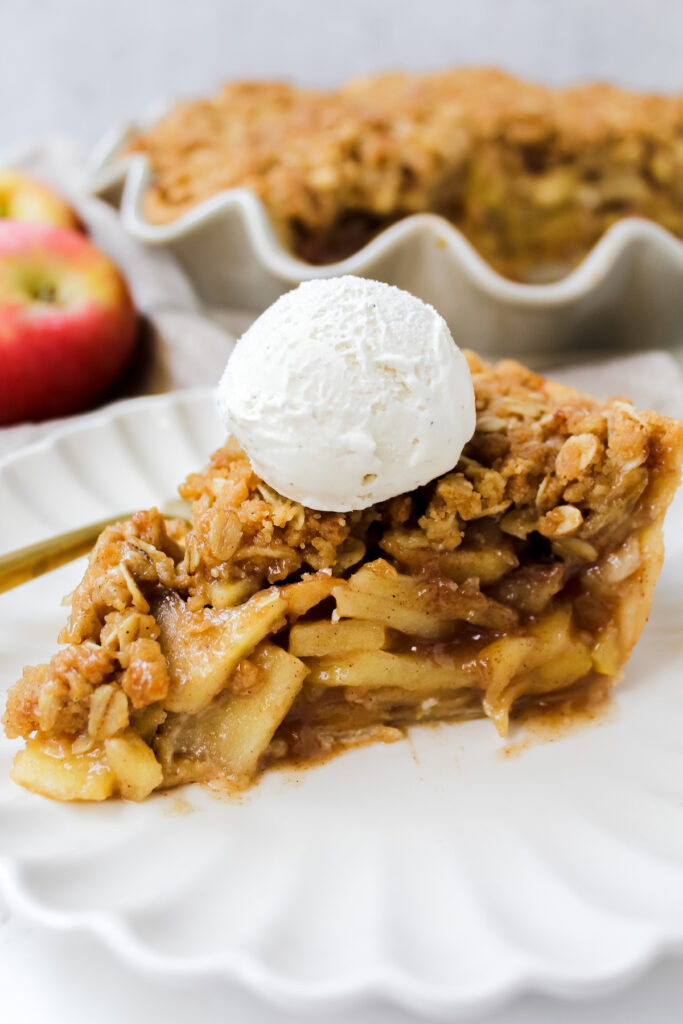 angled shot of a slice of pie with ice cream on top