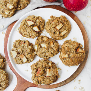 overview shot of apple pie oatmeal cookies on plate and on the sides