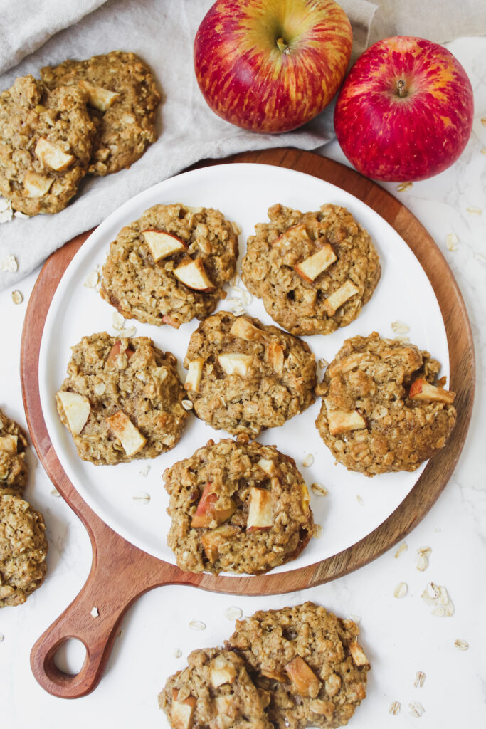 overview shot of apple pie oatmeal cookies on plate and on the sides