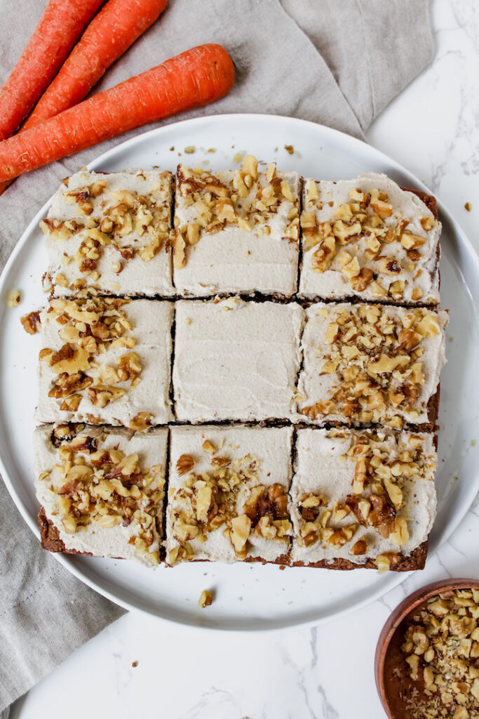 overview shot of entire carrot cake that is sliced