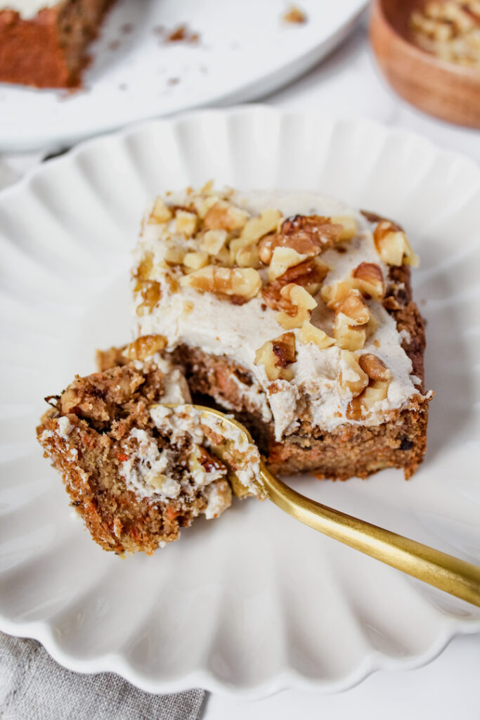 fork cut into a corner of a slice of carrot cake