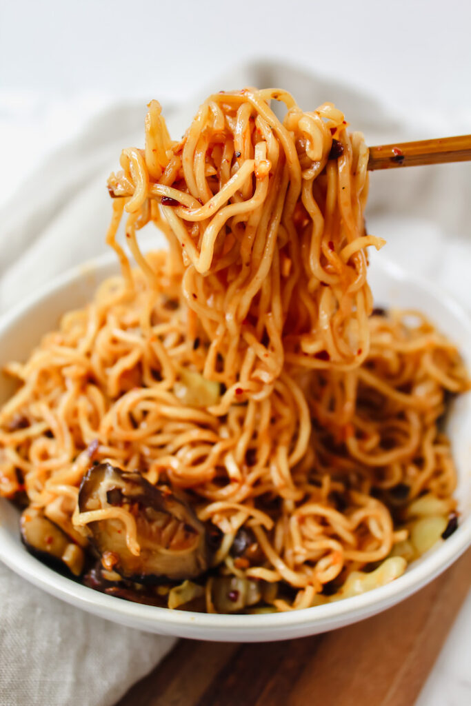 chopsticks pulling noodles out of the bowl