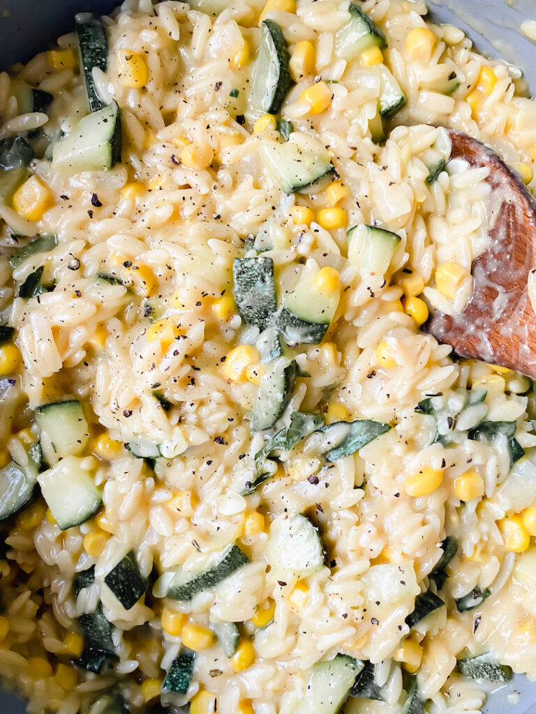 close up shot of the creamy vegan lemon corn and zucchini orzo