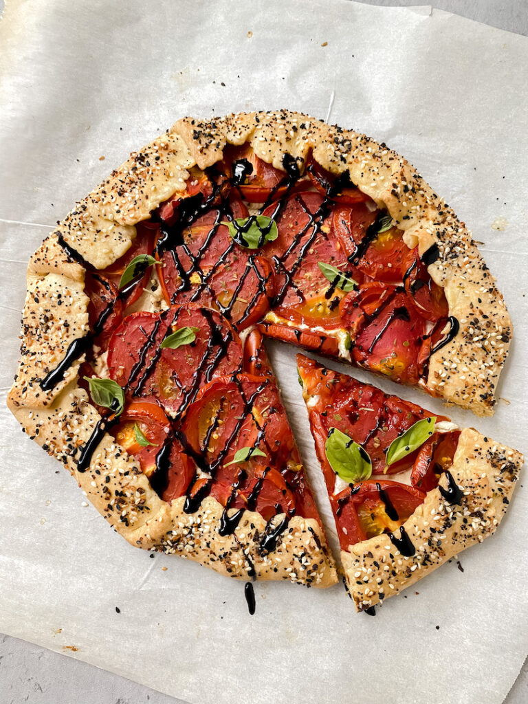 overview shot of tomato galette with a slice cut out