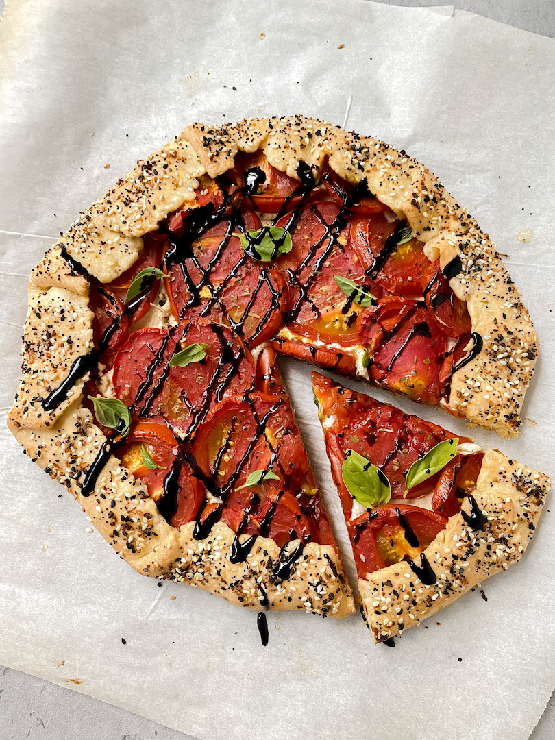 overview shot of tomato galette with a slice cut out