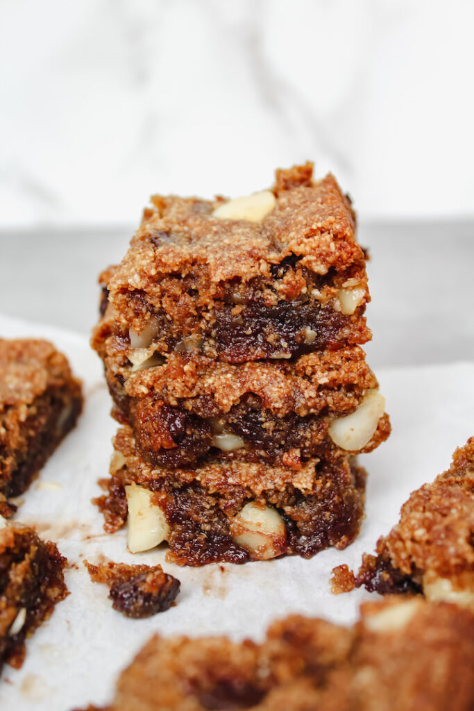 stack of dark chocolate macadamia nut blondies