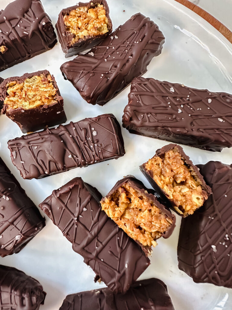 overview shot of some whole healthy homemade butterfingers and some cut in half