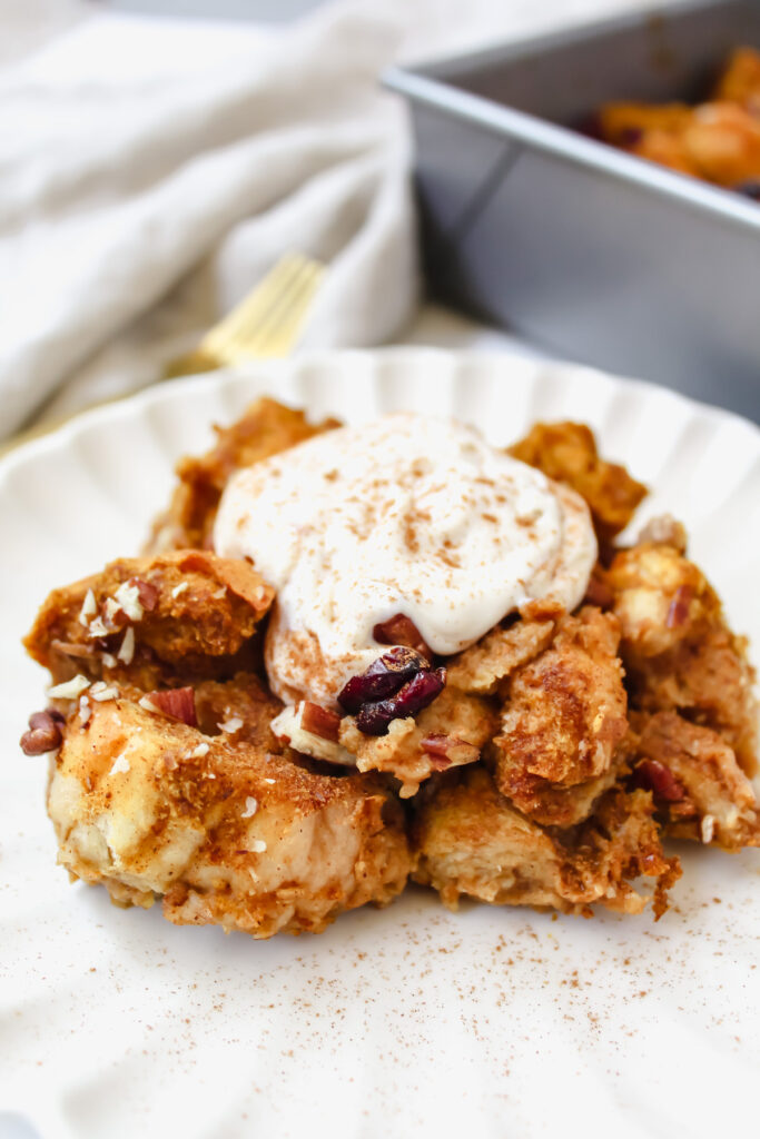 angled shot of french toast on a plate with yogurt on top