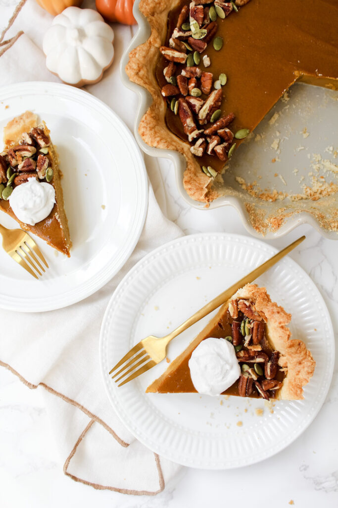 overview shot of two slices of pumpkin pie on plates