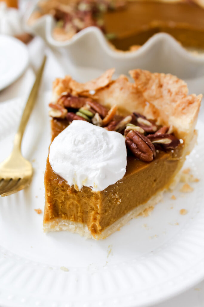 a bite out of a slice of pumpkin pie