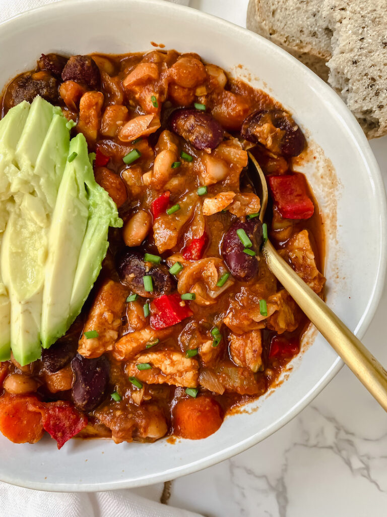 overview shot of easy tempeh chili with spoon in the bowl