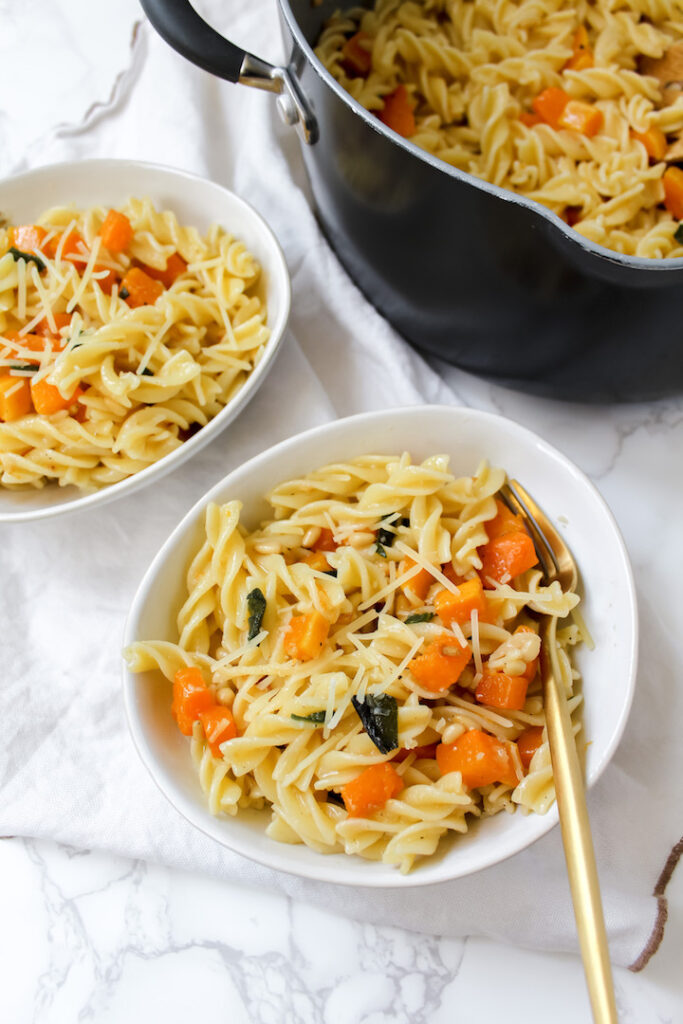 overview shot of two bowls of vegan brown butter sage pasta with roasted butternut squash