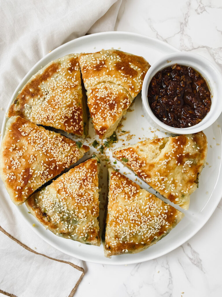 plate of cut up chinese sesame scallion bread and XO sauce