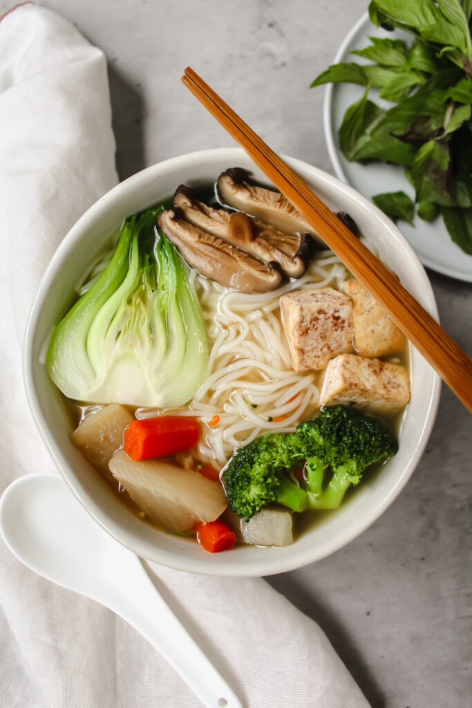 chopsticks on a bowl of vegan pho