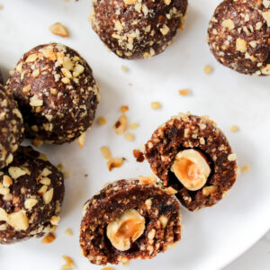 photo of a ferrero rocher ball cut in half and other whole balls