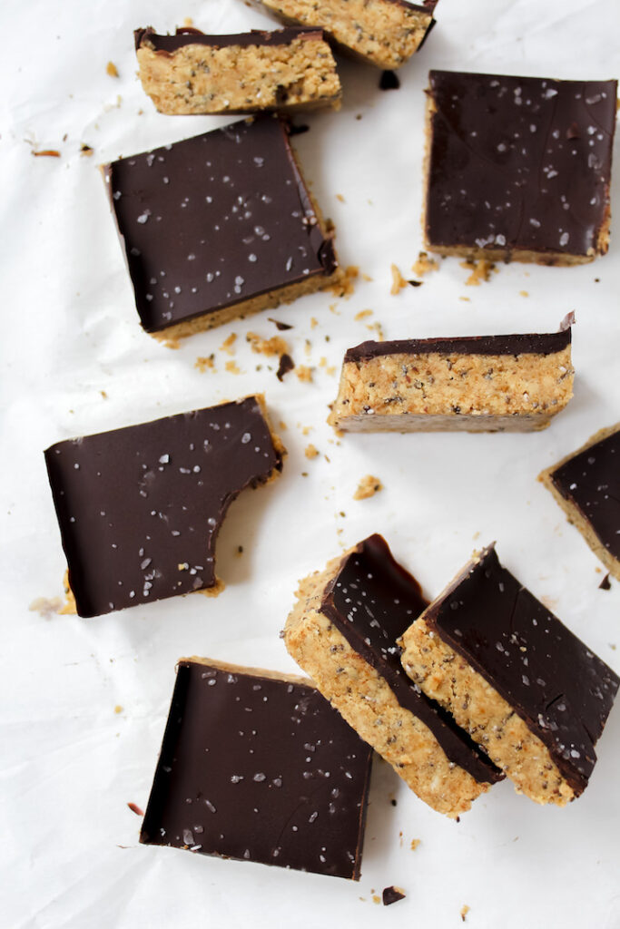 picture of protein bars on a piece of parchment paper with a bite taken out of one bar