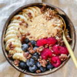 bowl of easy instant pot steel cut oats with toppings and a spoon in it