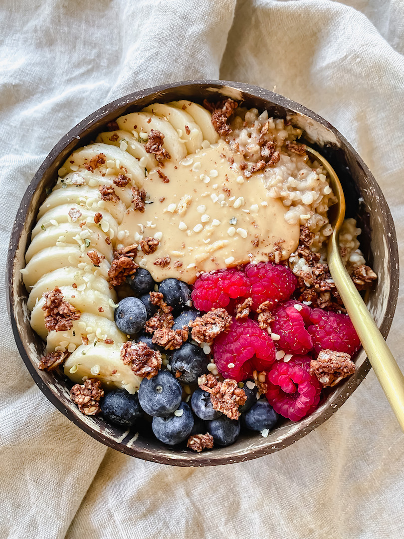 bowl of easy instant pot steel cut oats with toppings and a spoon in it