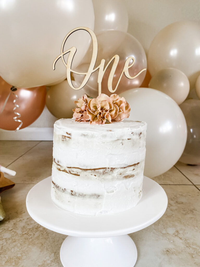 picture of the healthy baby smash cake with flowers and a number one cake topper