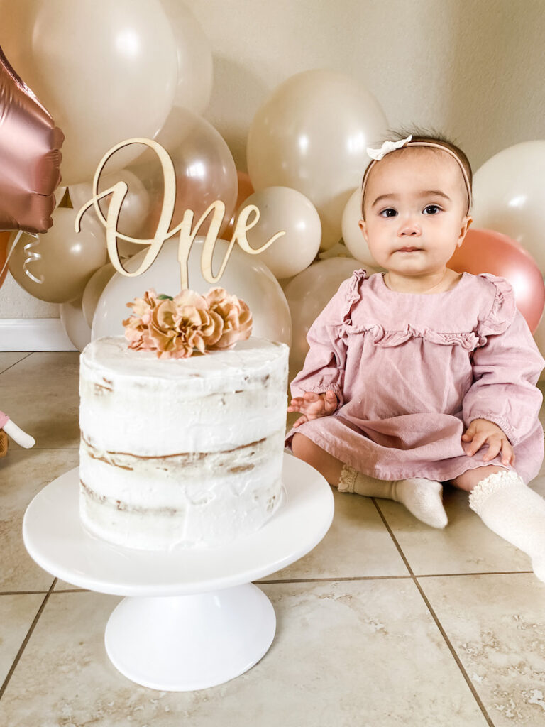 Sophie sitting next to her cake