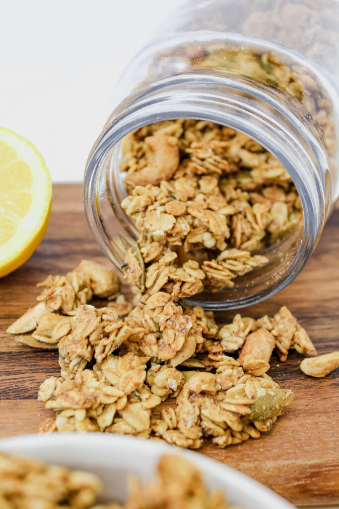 jar of granola on it's side with granola spilling out of it