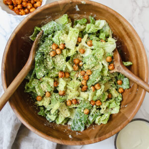 overview shot of a wooden bowl with vegan caesar salad