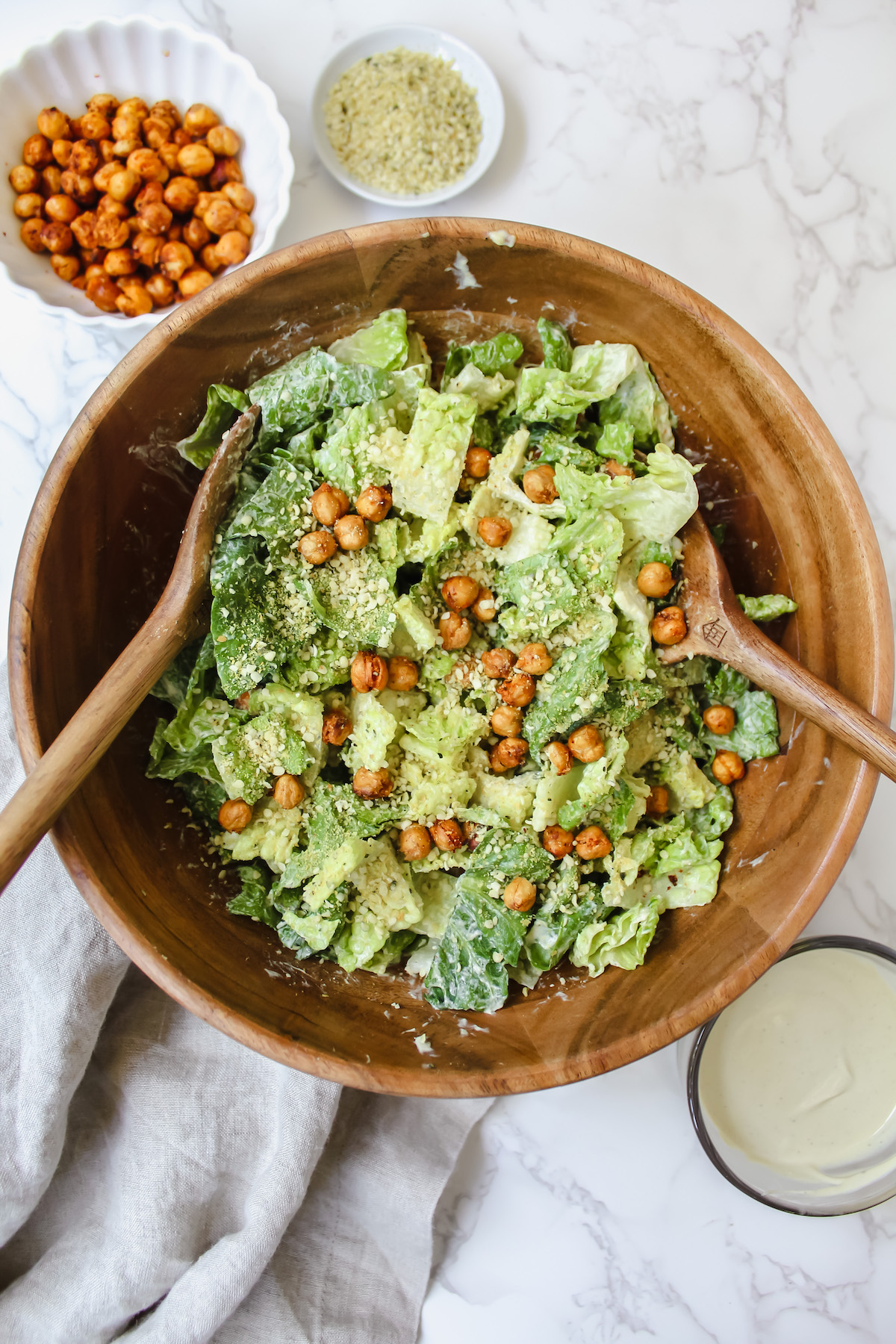 overview shot of a wooden bowl with vegan caesar salad