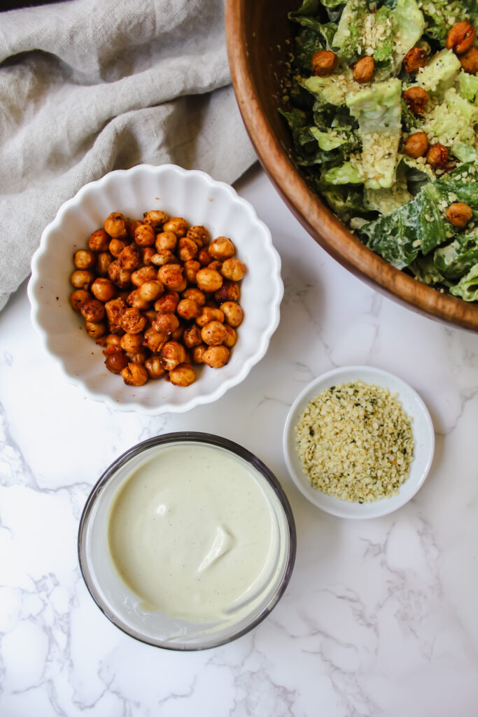 shot of dressing, crispy chickpeas, and hemp parm